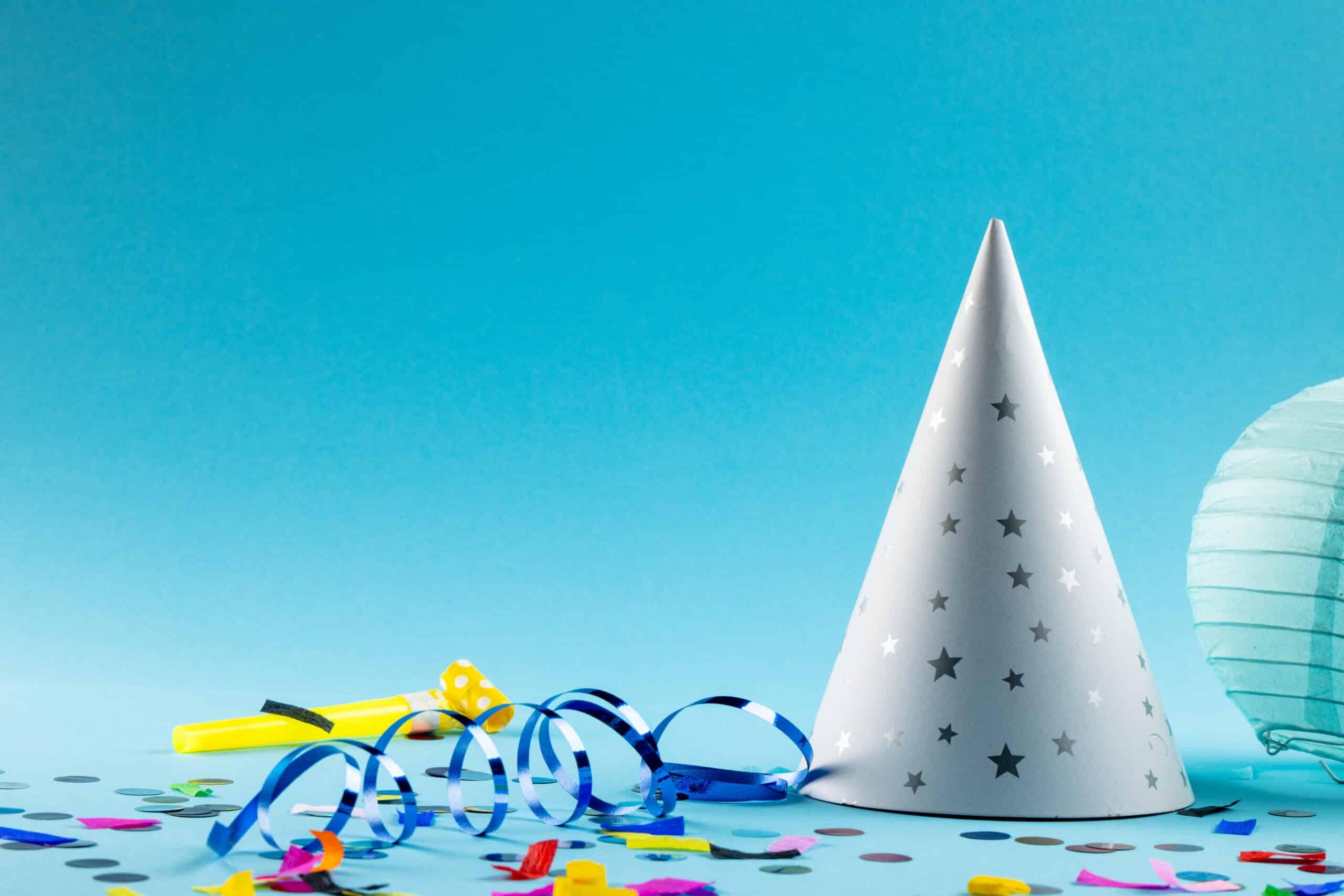Composition of close up of new years decorations on blue background. New year's eve party, celebration and copy space concept.